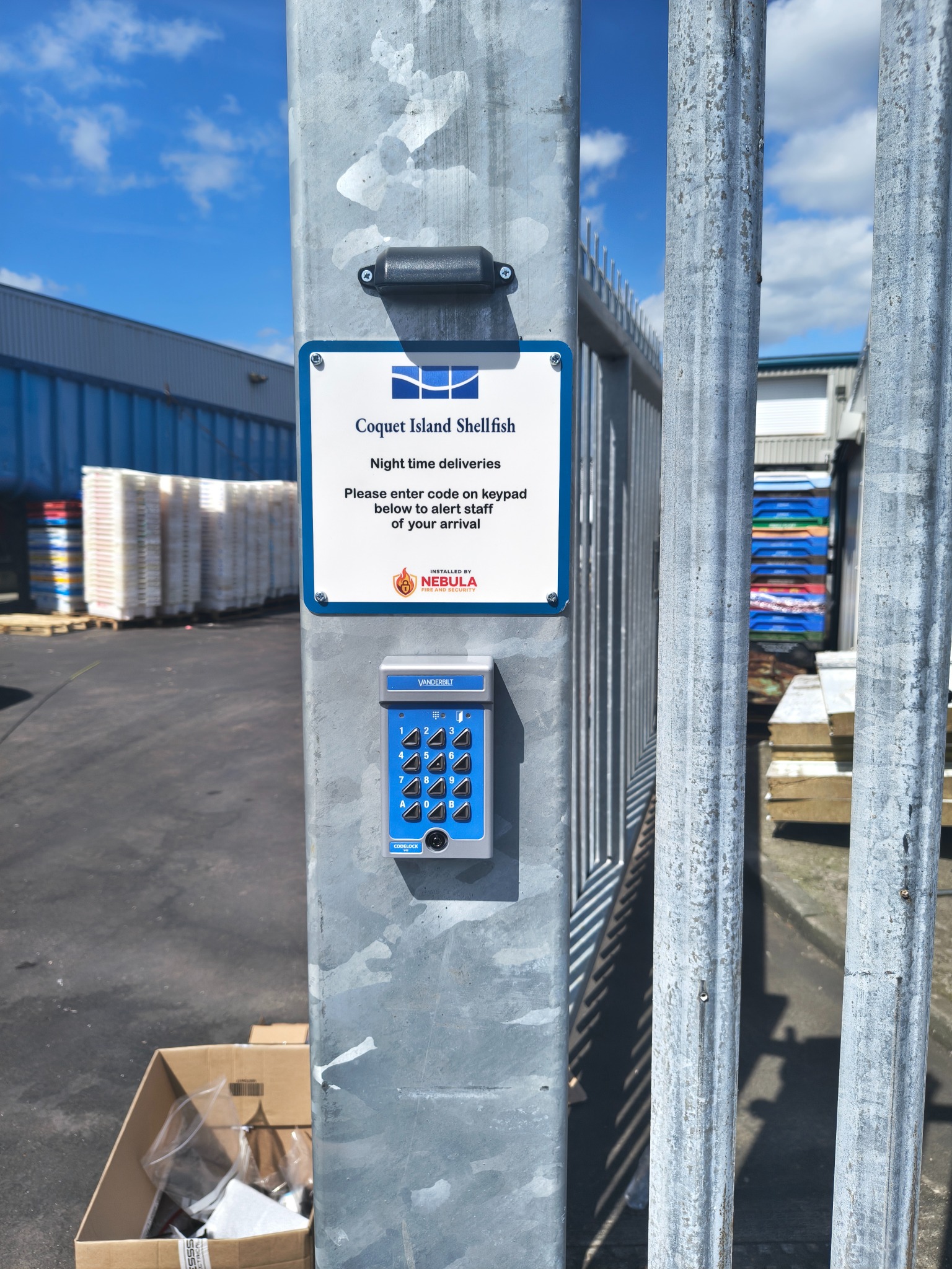 Door access keypad fitted to a metal gate post