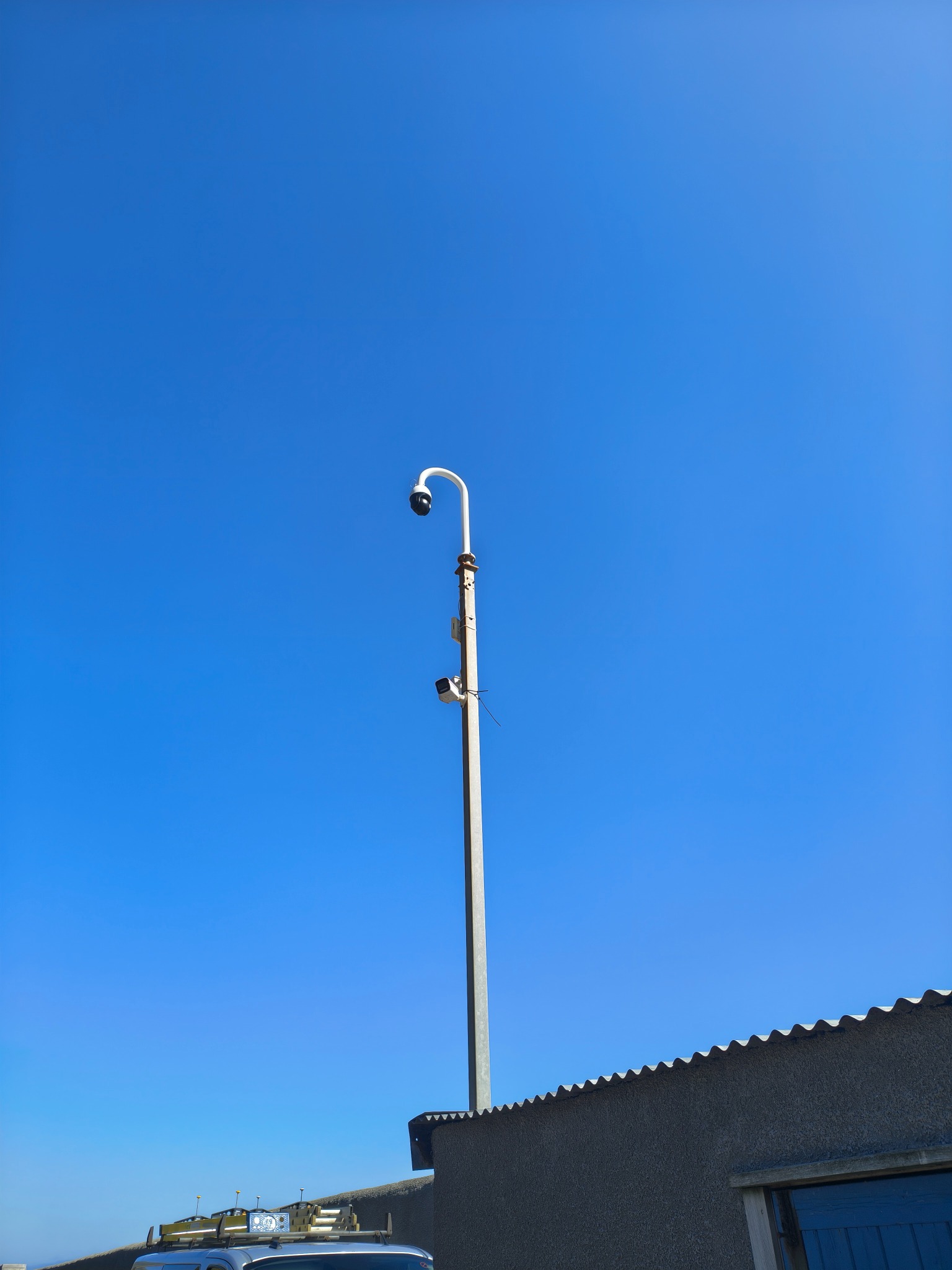 Pole mount for CCTV equipment outside a building
