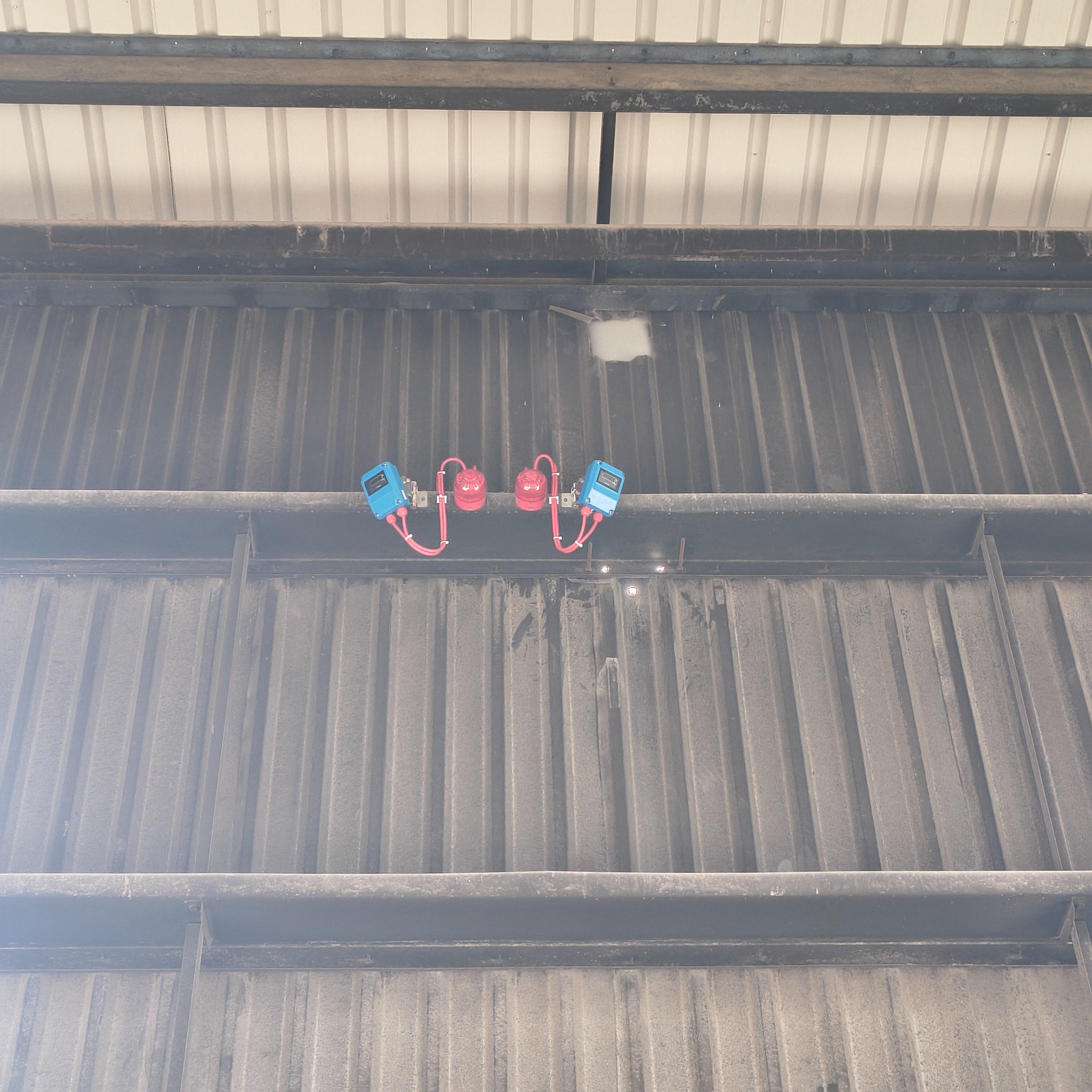 Fire detection devices installed high on a warehouse wall