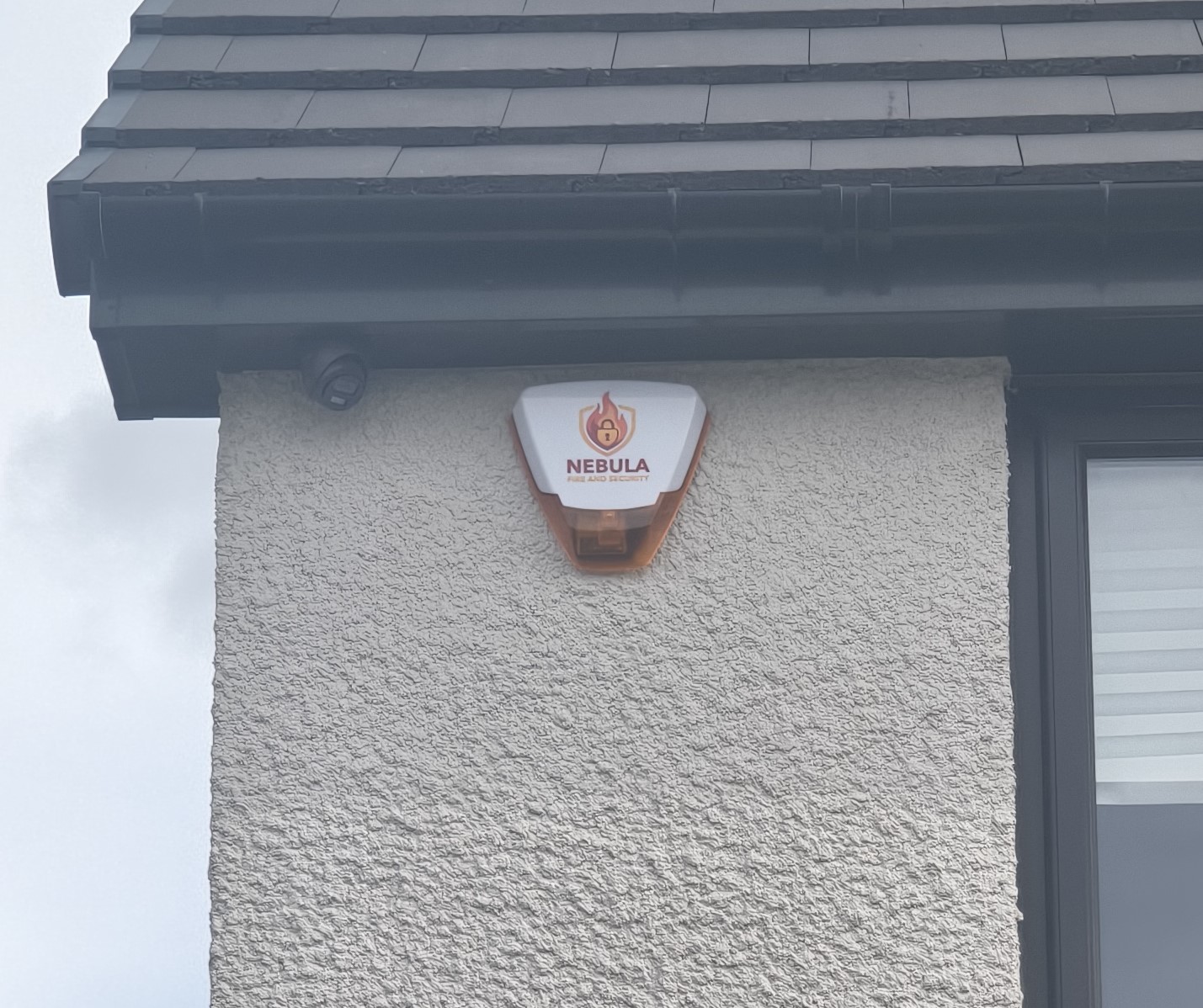 Nebula branded intruder alarm bell box on an exterior wall