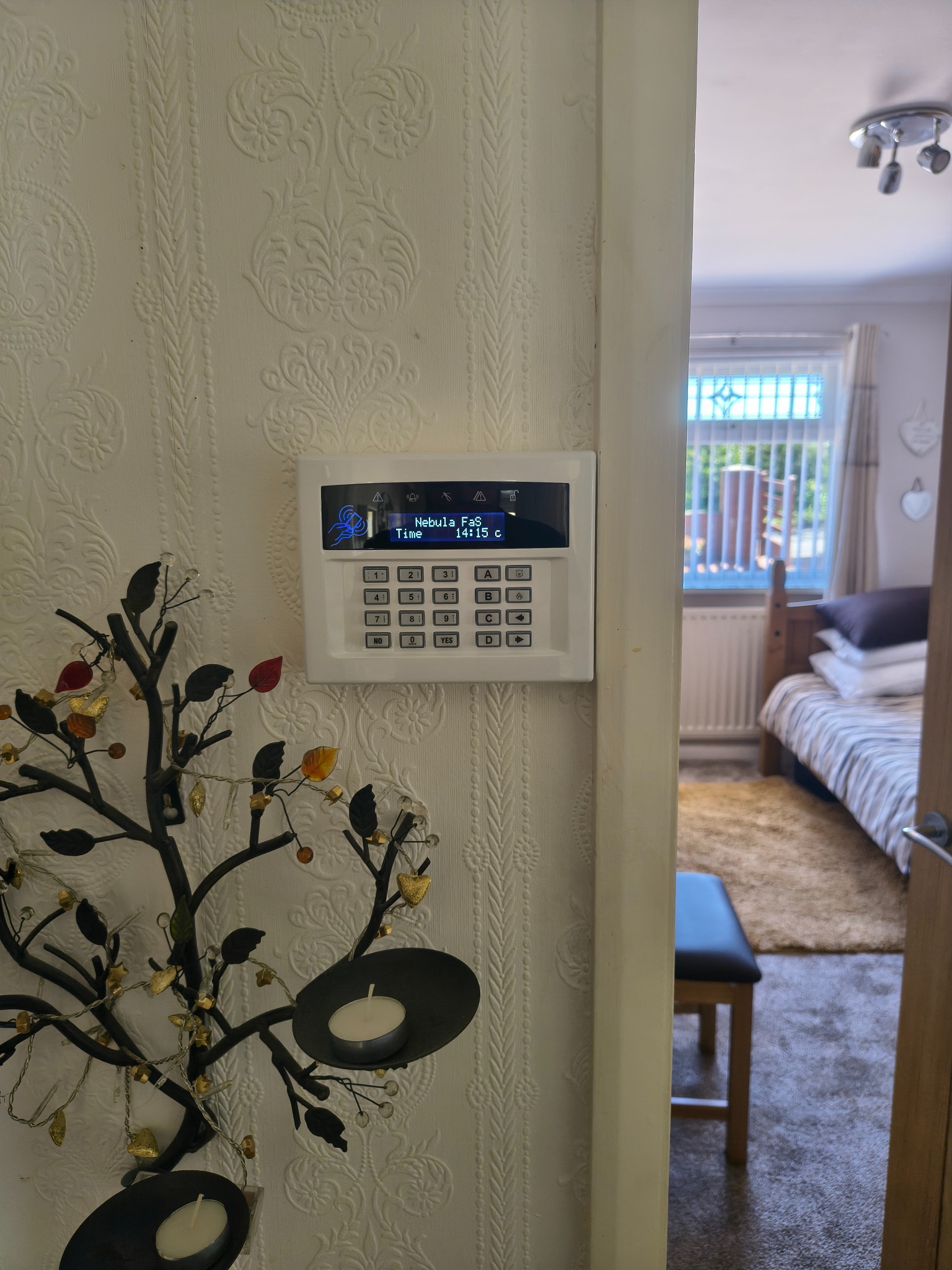 Intruder alarm keypad installed indoors