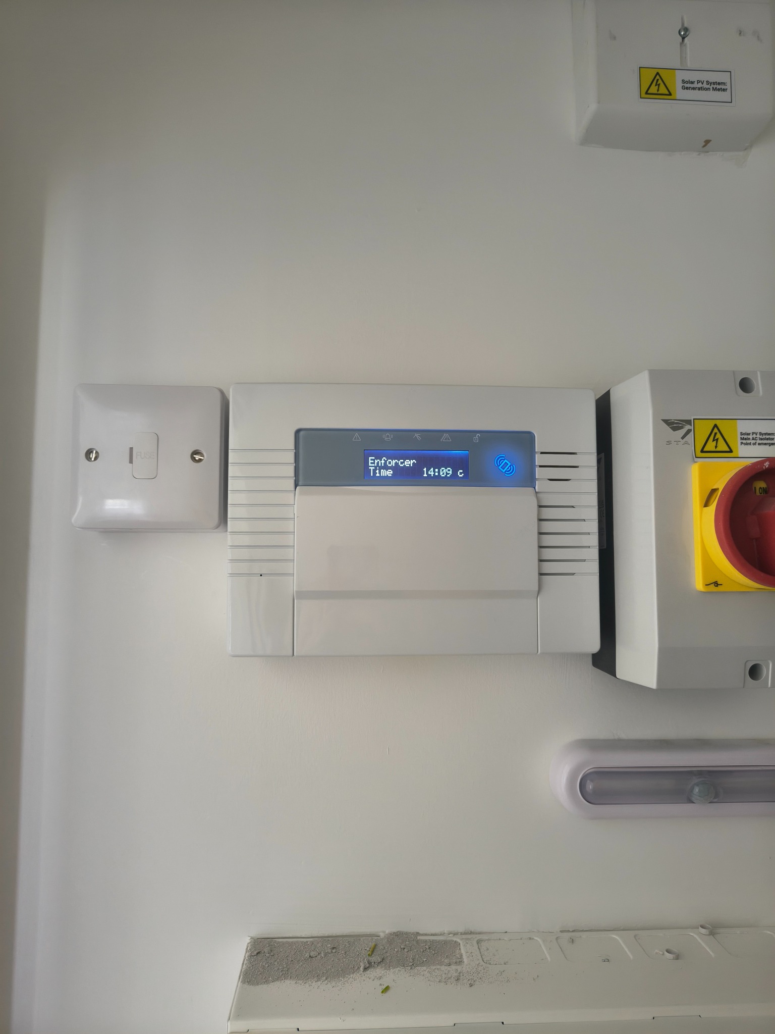 Pyronix Enforcer alarm control panel mounted on a wall